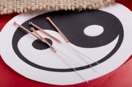 Yin yang symbol and acupuncture needles